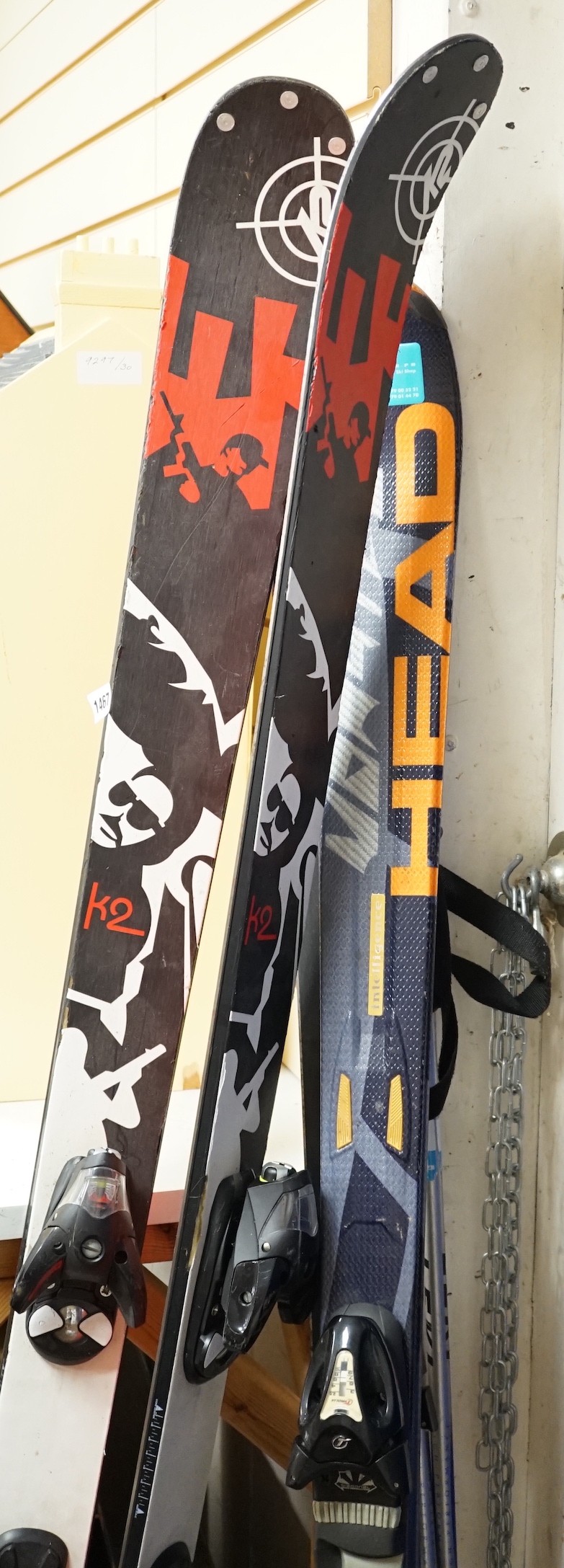 A pair of K2 skis, a pair of Head intelligence skis and a pair of Lexi ski poles
